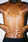 Lower back tension — hands on lower back