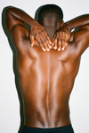 Man rubbing upper back muscles