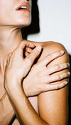 Woman touching neck and shoulder