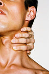 Person holding their neck